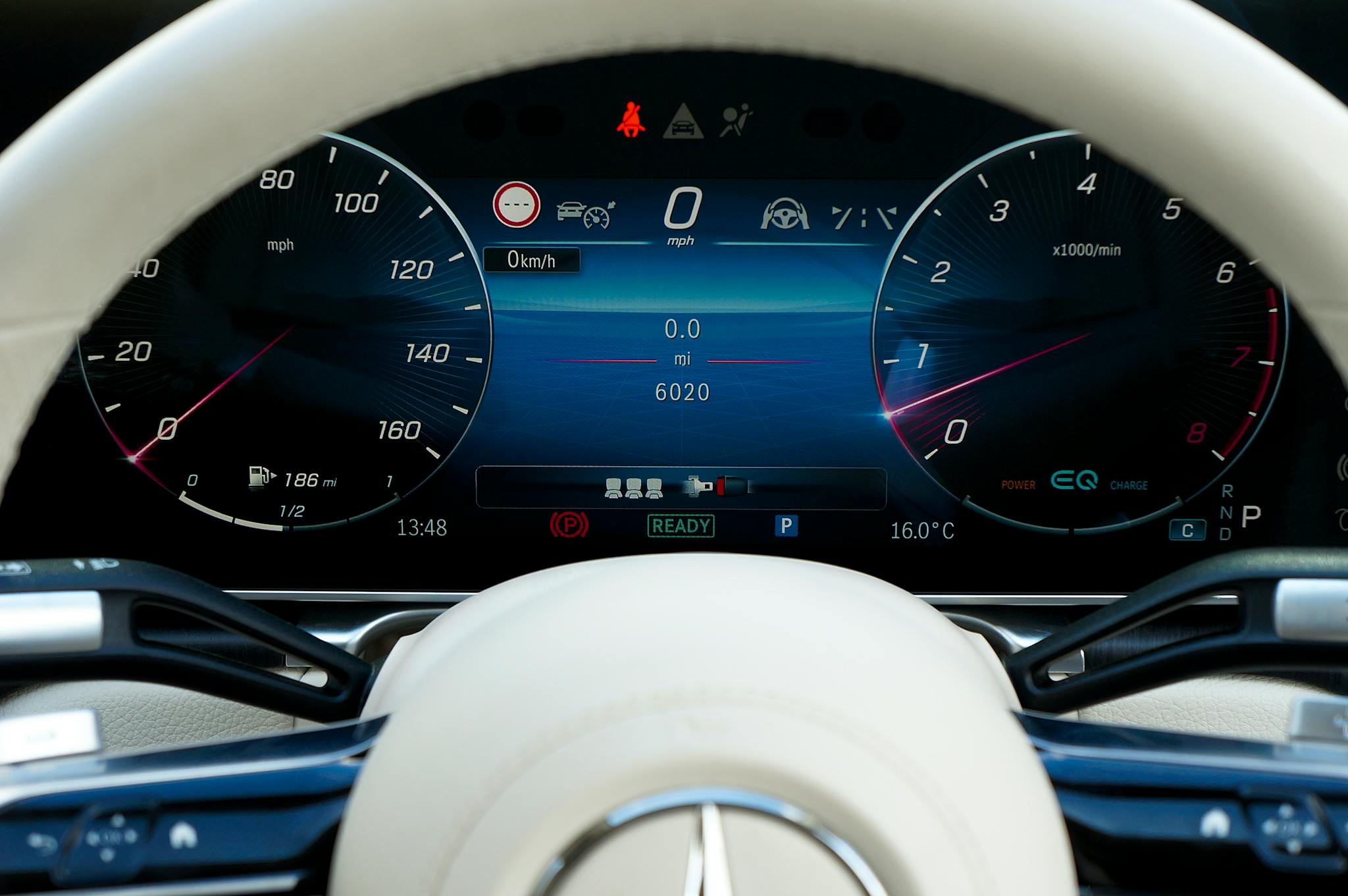 Close-up of a modern car dashboard showcasing digital gauges and technology.